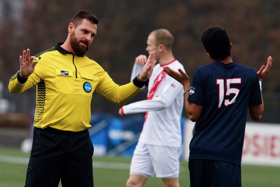 An official manages players during a match